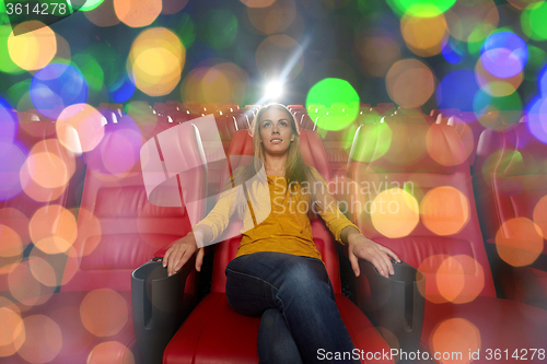 Image of young woman watching movie in theater