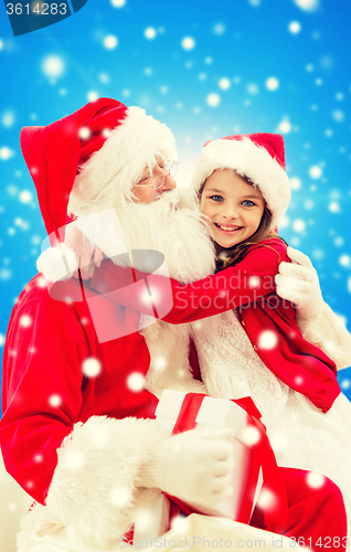 Image of smiling little girl with santa claus