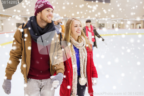 Image of happy friends on skating rink