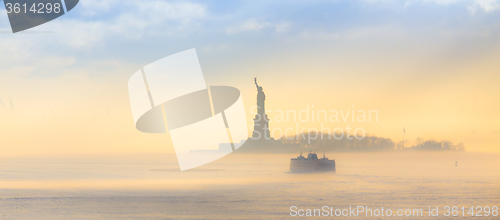 Image of Staten Island Ferry cruises past the Statue of Liberty.