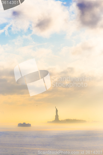 Image of Staten Island Ferry cruises past the Statue of Liberty.