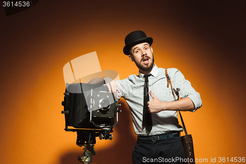 Image of young man with retro camera 