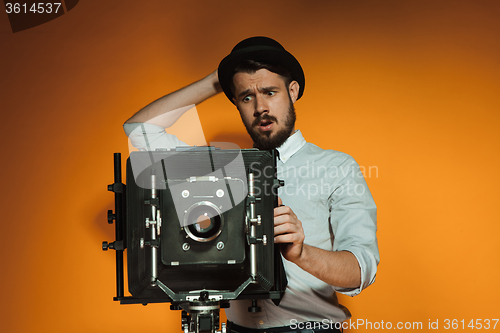 Image of young man with retro camera 