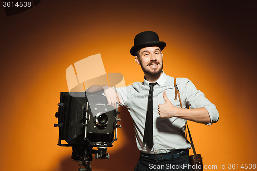 Image of young man with retro camera 