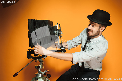 Image of young man with retro camera 