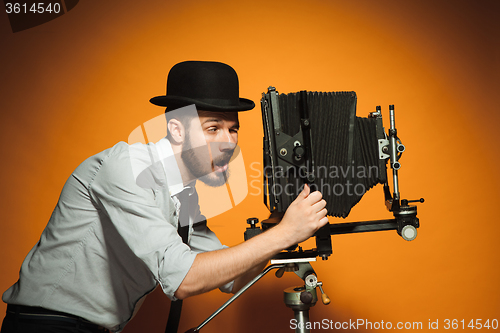 Image of young man with retro camera 