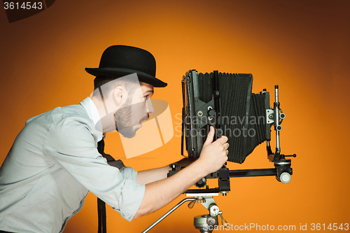 Image of young man with retro camera 