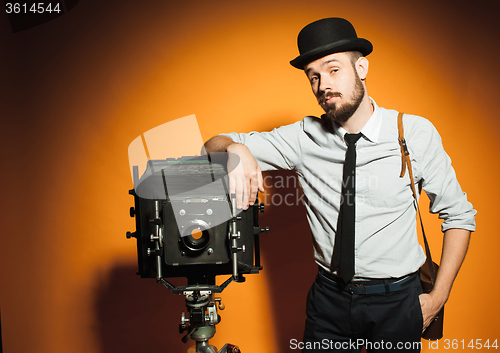 Image of young man with retro camera 