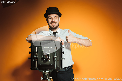 Image of young man with retro camera 