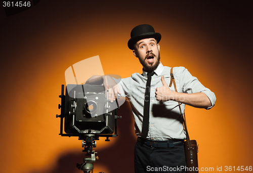 Image of young man with retro camera 