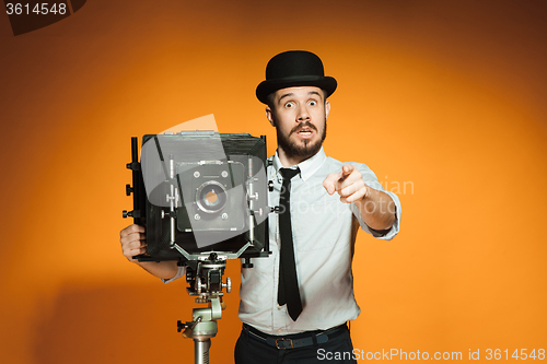 Image of young man with retro camera 