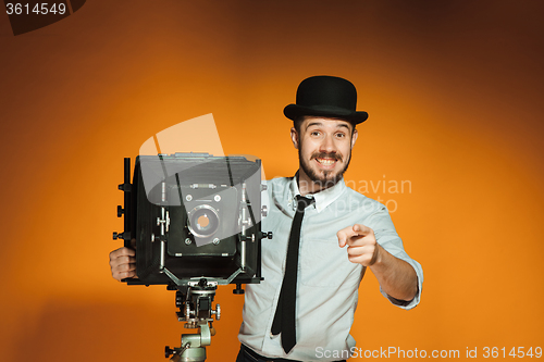 Image of young man with retro camera 