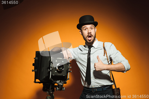 Image of young man with retro camera 