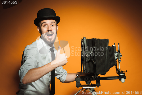 Image of young man with retro camera 