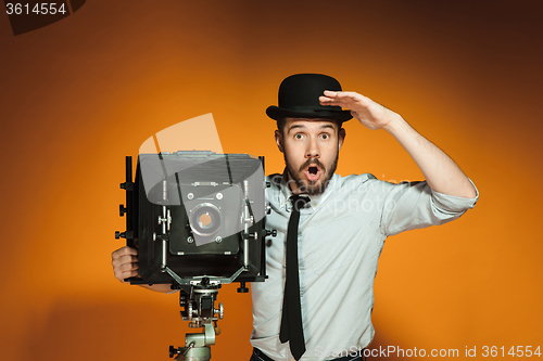 Image of young man with retro camera 