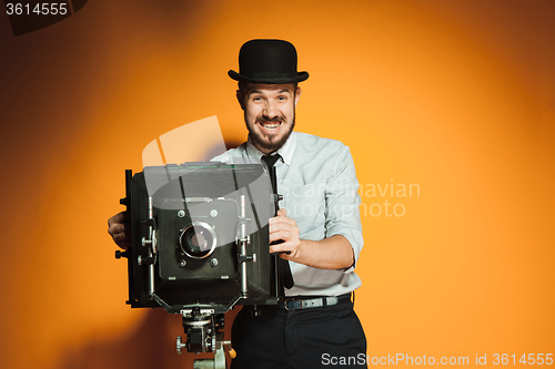 Image of young man with retro camera 