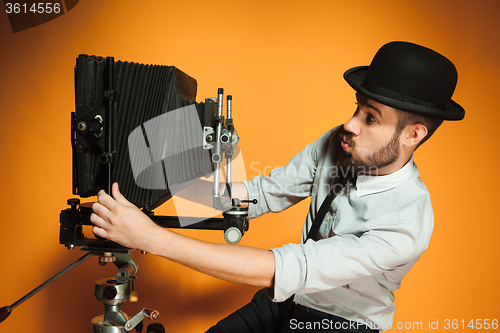 Image of young man with retro camera 