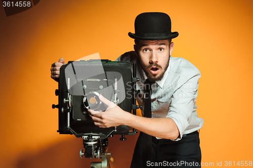 Image of young man with retro camera 