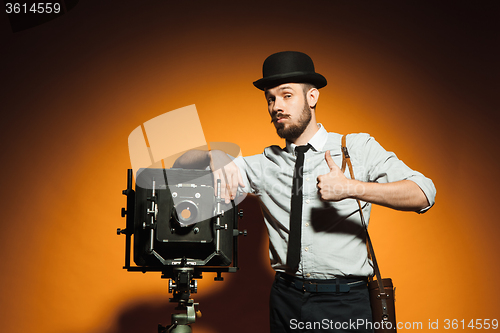 Image of young man with retro camera 
