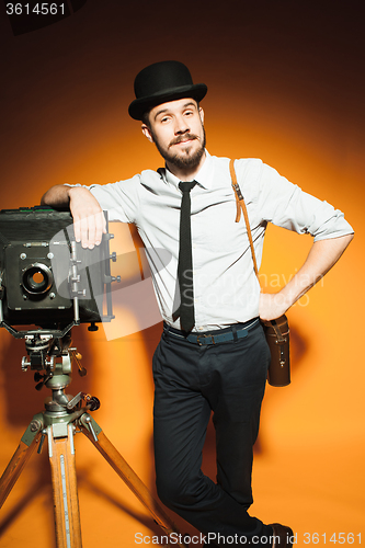 Image of young man with retro camera 