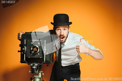 Image of young man with retro camera 