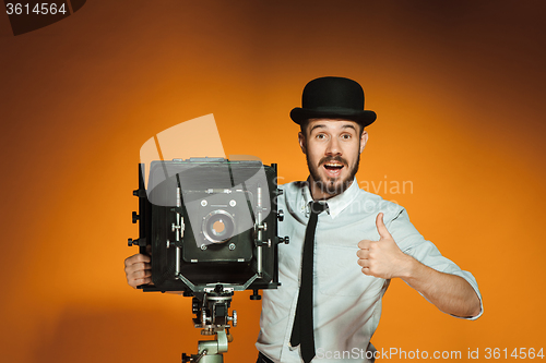 Image of young man with retro camera 