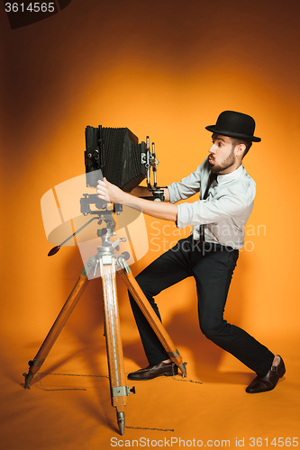 Image of young man with retro camera 