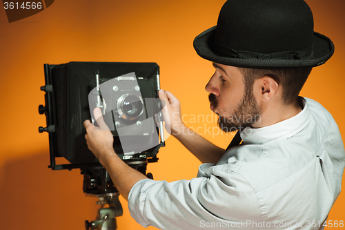 Image of young man with retro camera 