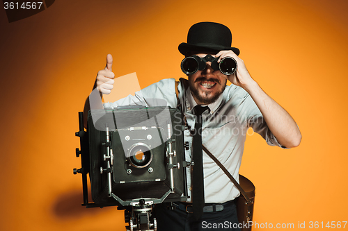 Image of young man with retro camera 