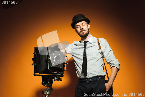 Image of young man with retro camera 