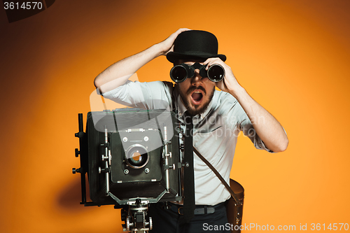 Image of young man with retro camera 