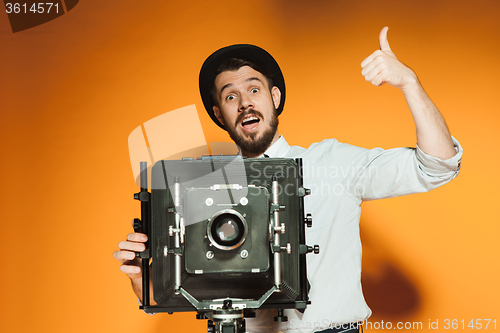 Image of young man with retro camera 