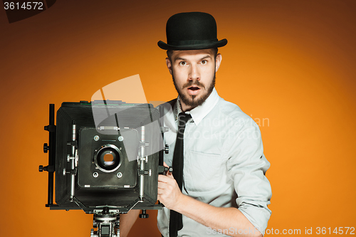 Image of young man with retro camera 