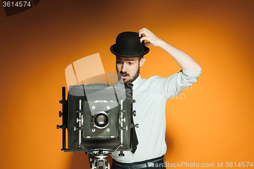 Image of young man with retro camera 