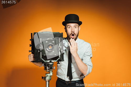 Image of young man with retro camera 