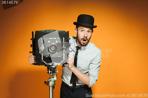 Image of young man with retro camera 