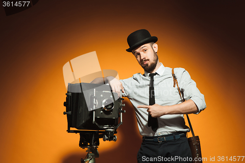 Image of young man with retro camera 