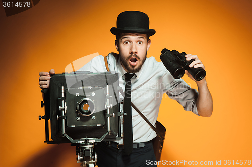 Image of young man with retro camera 