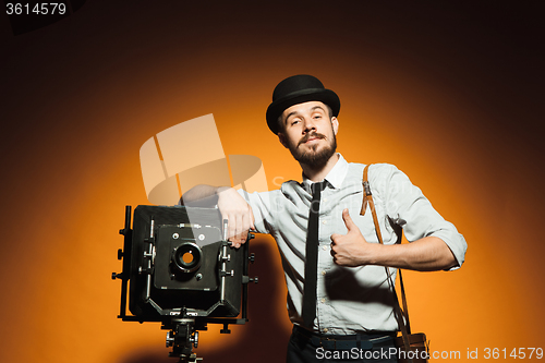 Image of young man with retro camera 