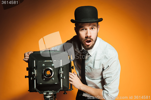 Image of young man with retro camera 