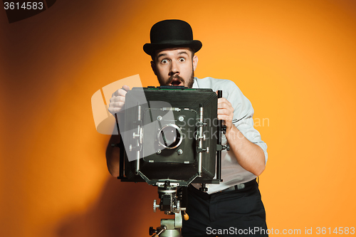 Image of young man with retro camera 