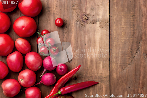 Image of The red vegetables on wooden table