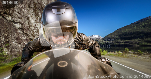 Image of Biker racing on the road