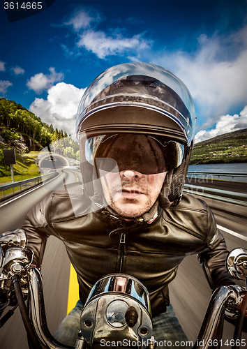 Image of Biker racing on the road