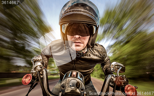 Image of Biker racing on the road