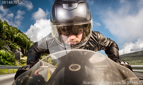 Image of Biker racing on the road