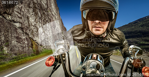 Image of Biker racing on the road