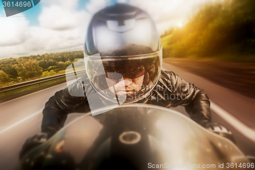 Image of Biker racing on the road