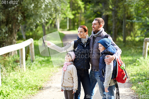Image of happy family with backpacks hiking