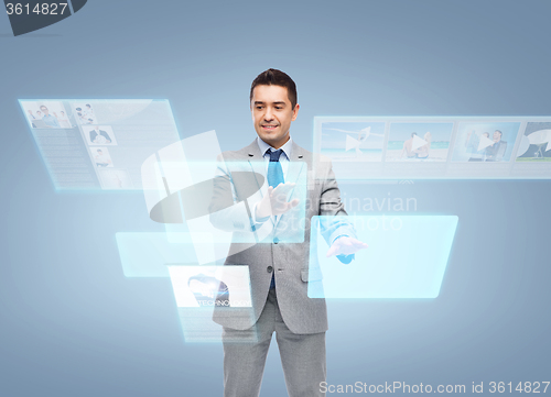 Image of businessman in suit working with virtual screens